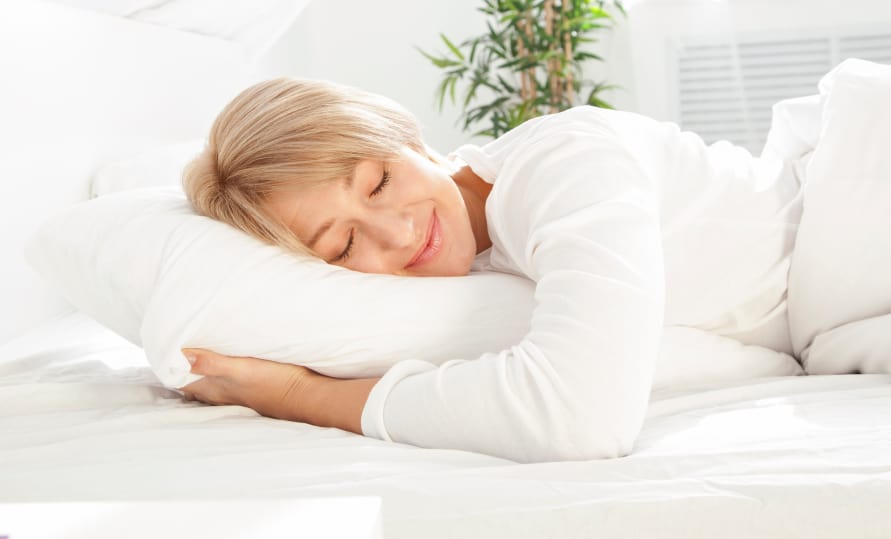 Beautiful woman sleeping in white bed