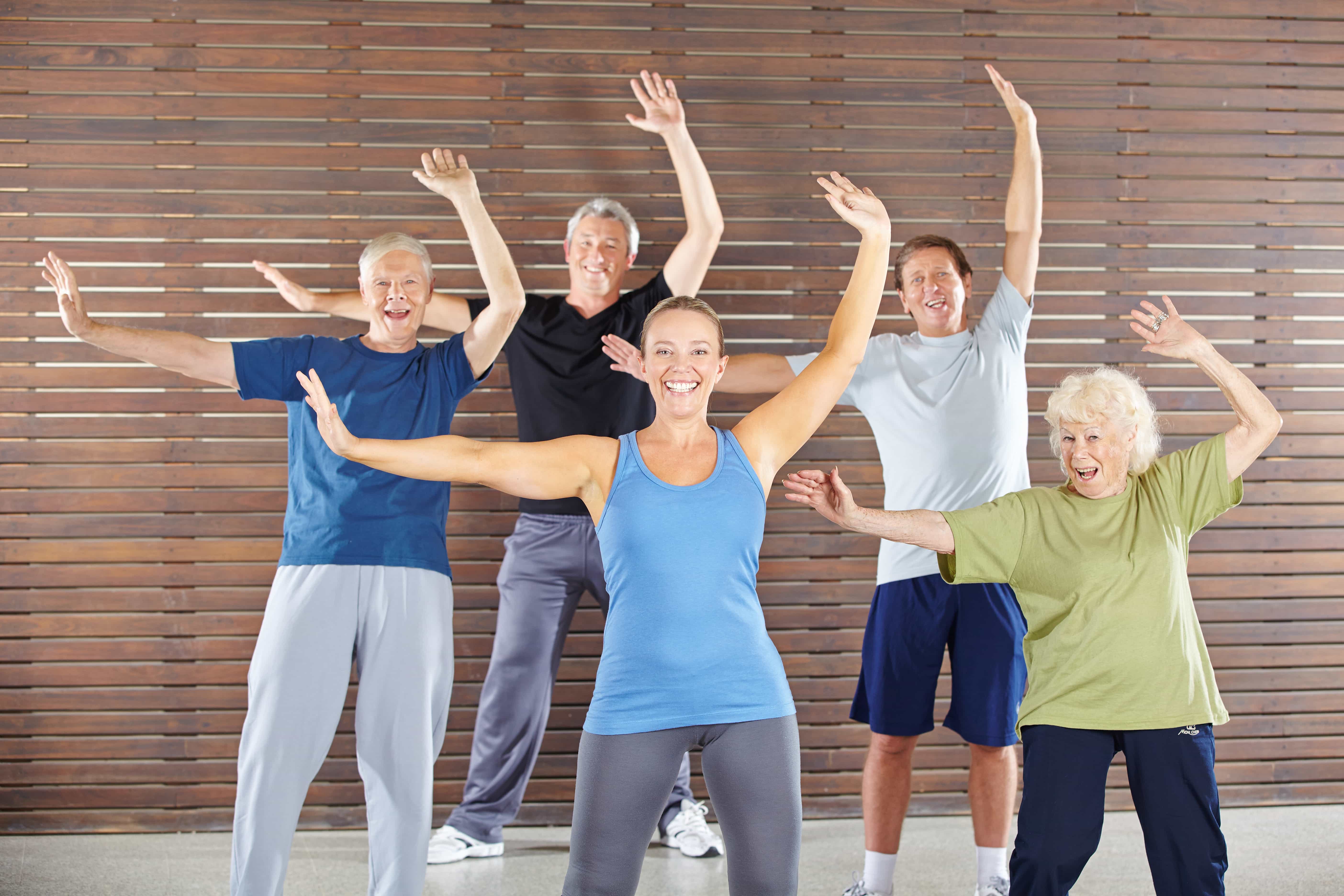 Seniors dancing and exercising in gym